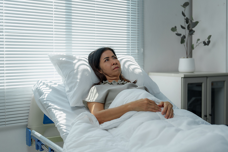 A woman on bed rest after colorectal surgery